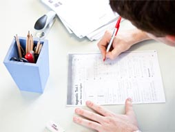 A person filling out a form